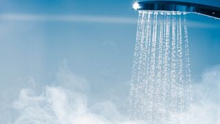 A running shower with steam forming below