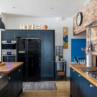 kitchen with wooden flooring and deep blue cupboard