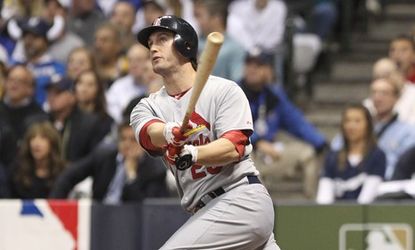 David Freese of the St. Louis Cardinals hits a three-run homer in the top of the first inning of Sunday's homer-packed game with the Milwaukee Brewers: Some critics say the game's six homers 