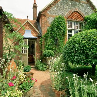 house with brick pathway and garden