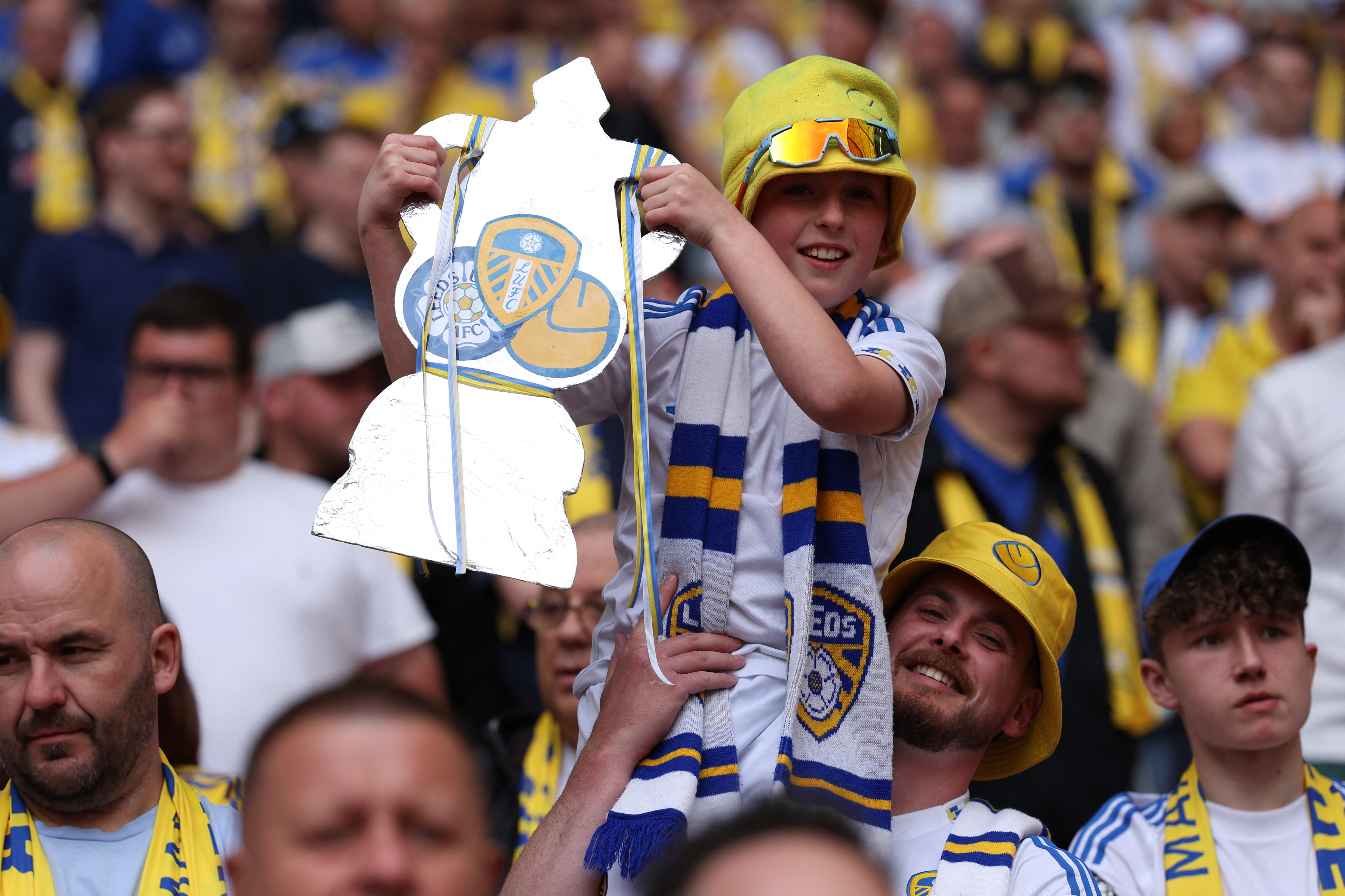 A young Leeds fans holds a tin-foil FA Cup in the crowd ahead of the English FA Cup semi final football match between Chelsea and Leeds United at Wembley stadium in London, on April 26, 2026. (Photo by Adrian Dennis / AFP) / NOT FOR MARKETING OR ADVERTISING USE / RESTRICTED TO EDITORIAL USE