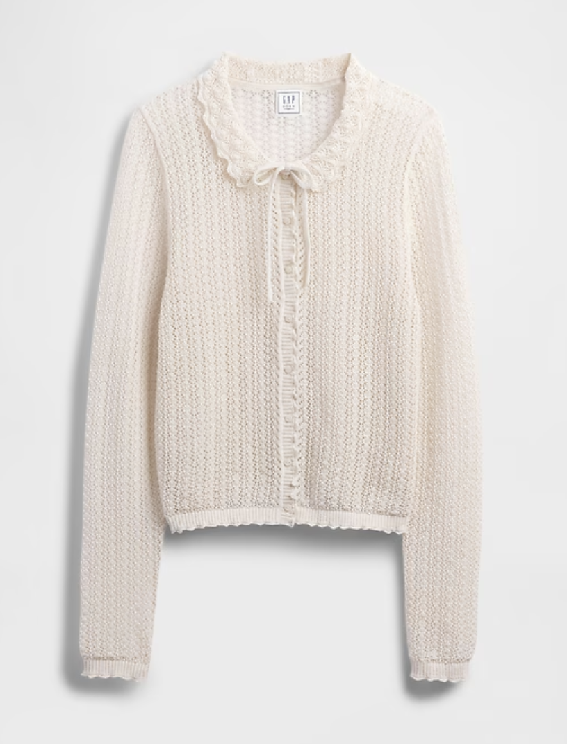 a gap doen sweater on a plain backdrop