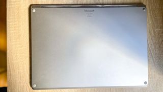 Surface Laptop 5 closed on desk, bottom facing up towards camera