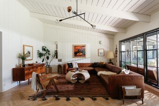 A living room with brown leather living room sofas