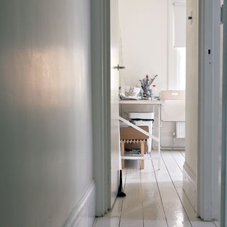 hallway with white walls and wooden flooring