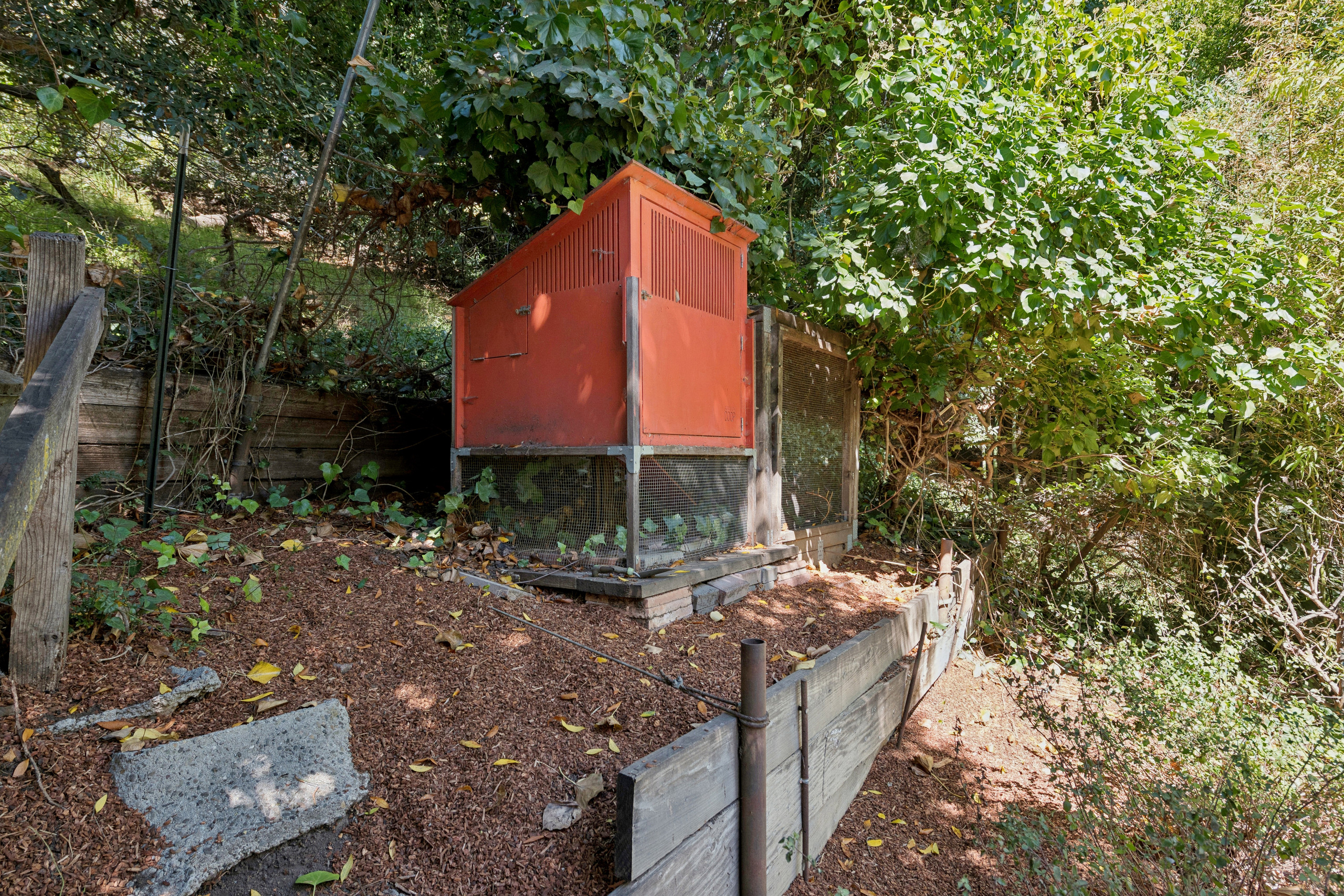 The yard includes a bespoke mid-century hen house