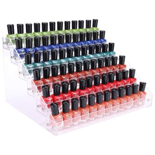 A six tier acrylic nail polish rack filled with orange, red, blue and green polishes