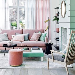 living room with pink and white curtains on window and pink sofa