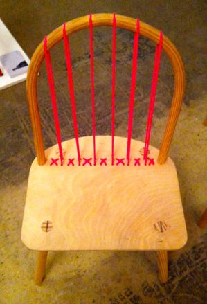 Simple wood chair with red ack bars