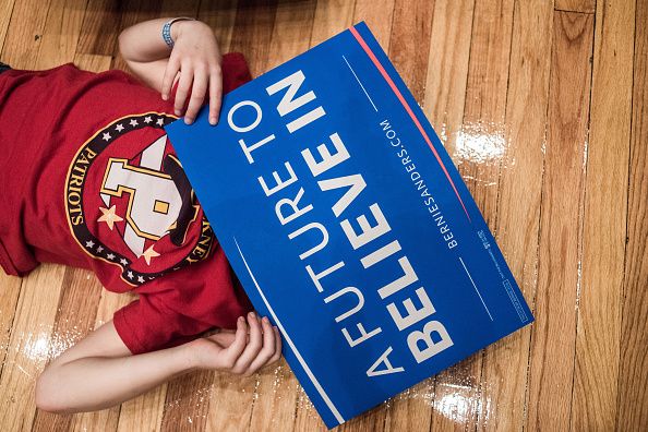 An eight-year-old supporter plays with a sign.