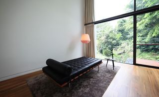 Black lounge sofa next to large window