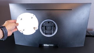 A picture of the backside of the Arzopa M3RC gaming monitor with a 3rd party VESA mount adapter used to mount it to a monitor arm