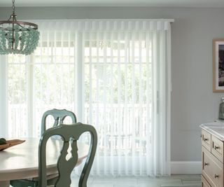 Dining room with sheer white curtains