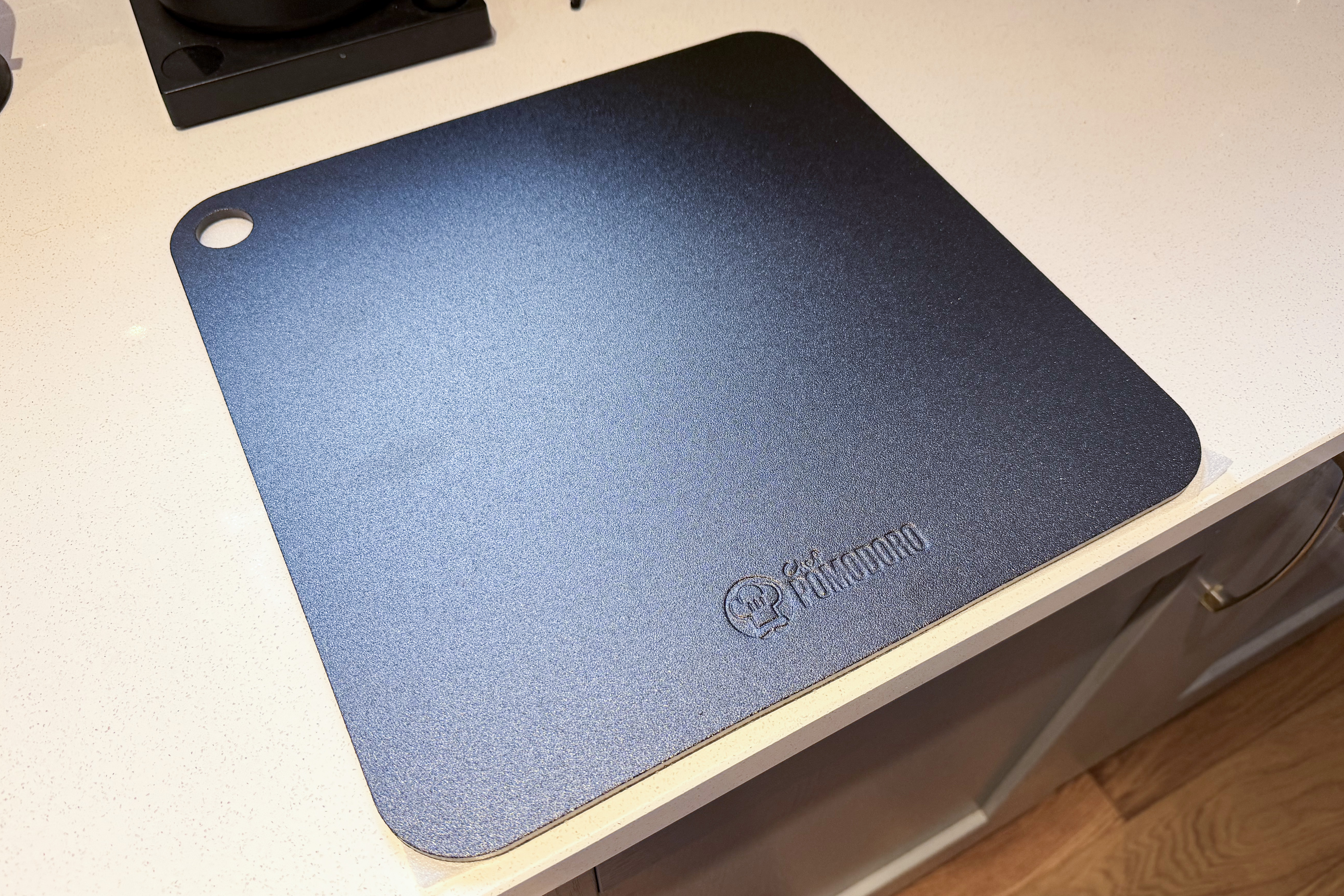 A pizza stone on a kitchen counter