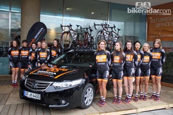 The Wiggle Honda Women's Pro Cycling team stand alongside their Honda team car