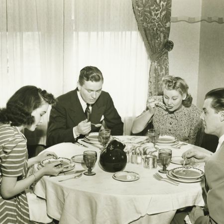 Two couples having dinner, (B&W)