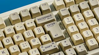 A beige, brown and off-white Epomaker RT100 wireless mechanical keyboard