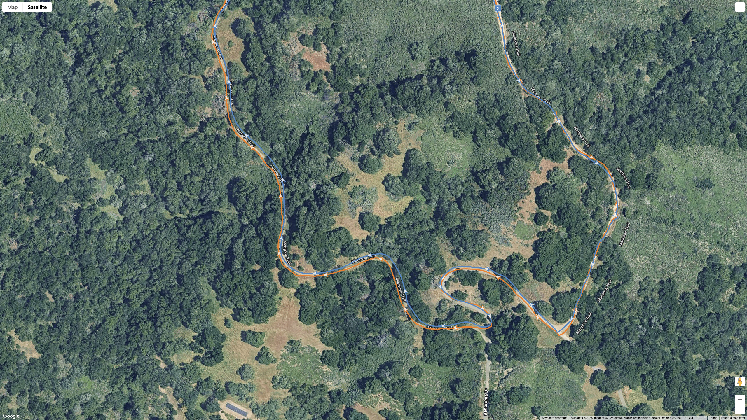 A Google Maps satellite view showing how the COROS APEX 4 (blue) and Garmin Forerunner 970 (orange) compare for GPS-tracked accuracy on a hilly, windy hike.