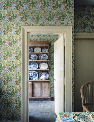 floral green wallpaper with china cabinet