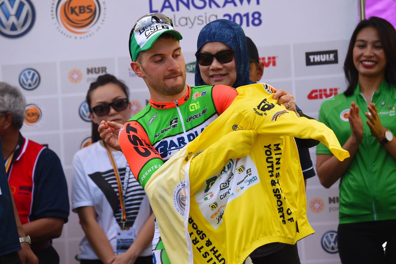 Andrea Guardini pulls on the yellow jersey