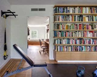 A small home gym integrated into a book room/library