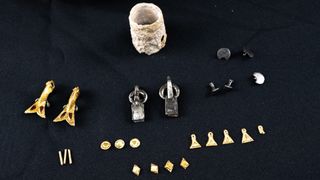 An array of gold and silver jewelry laid out on a table