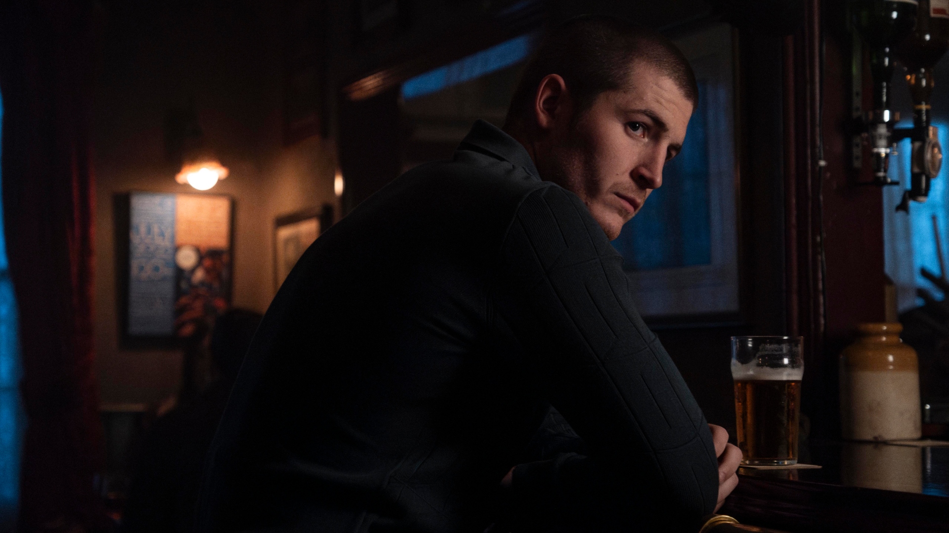 Liam sits at the bar in Code of Silence