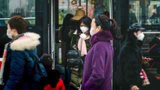 Commuters in Chengdu, China, don face masks amidst the coronavirus outbreak, on Jan. 23, 2020.