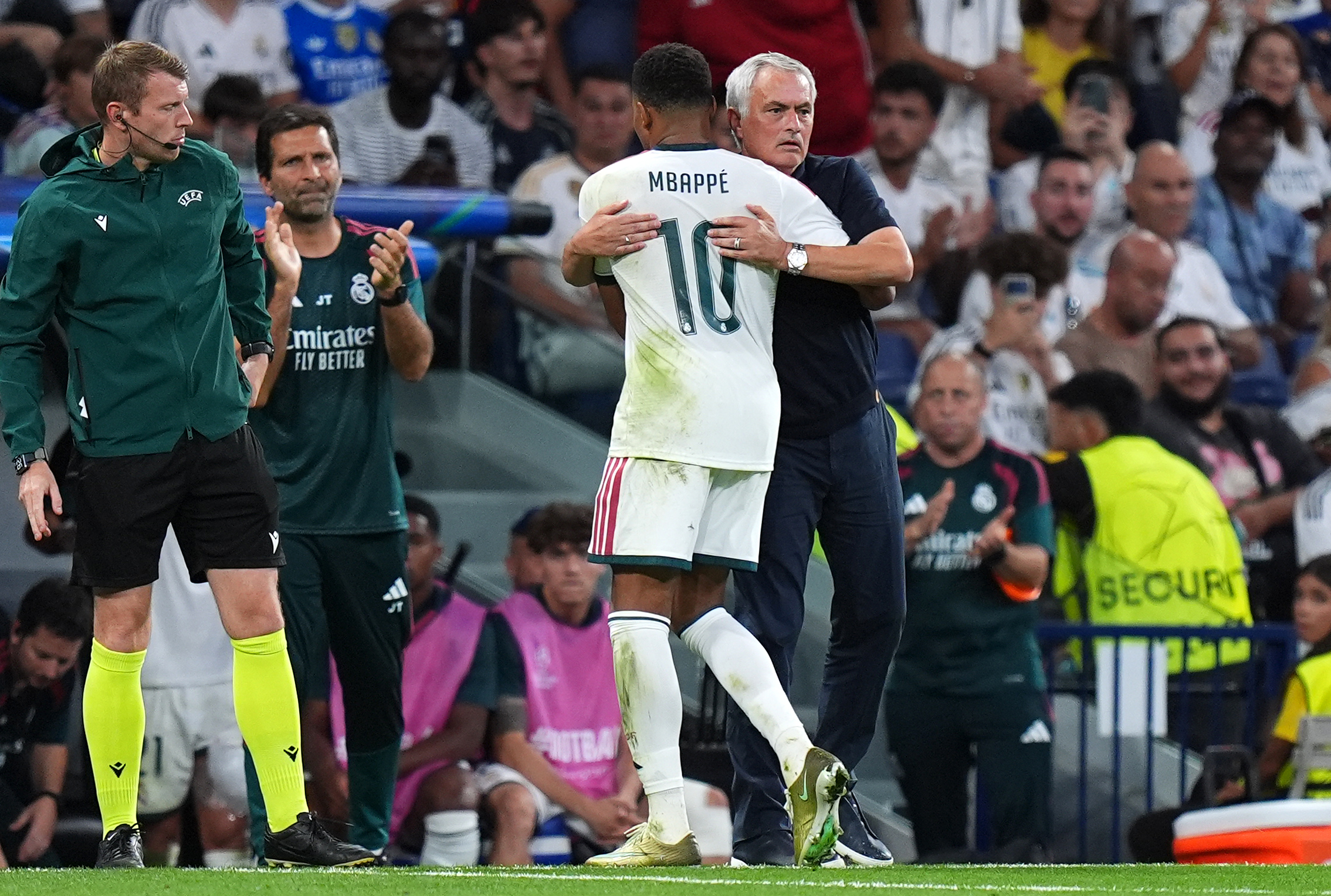 Kylian Mbappe of Real Madrid interacts with Jose Mourinho, Head Coach of Real Madrid as he is substituted off