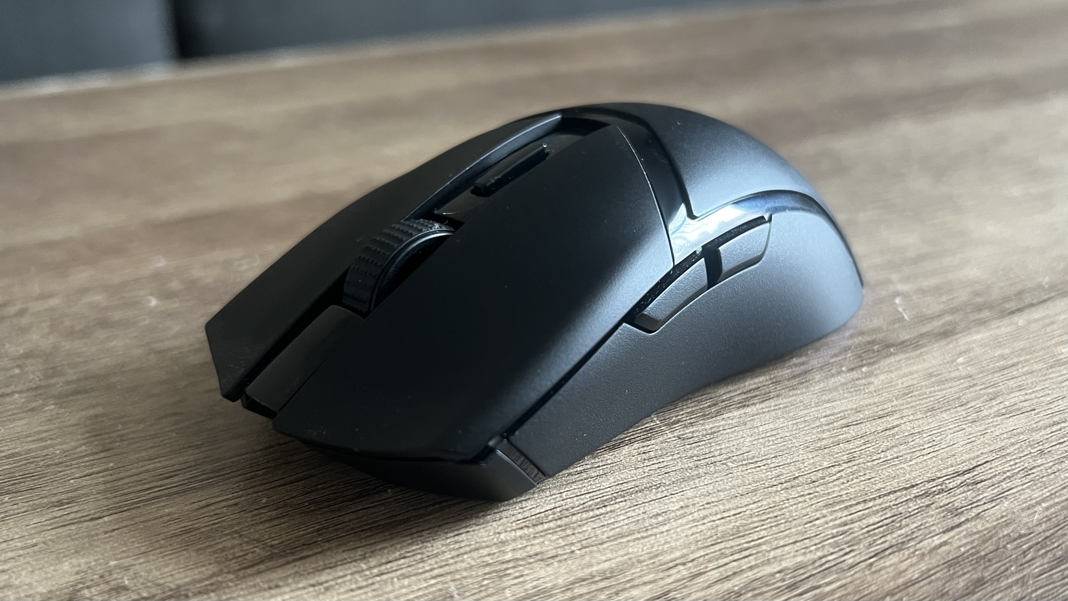 Razer Cobra Hyperspeed gaming mouse on a wooden desk