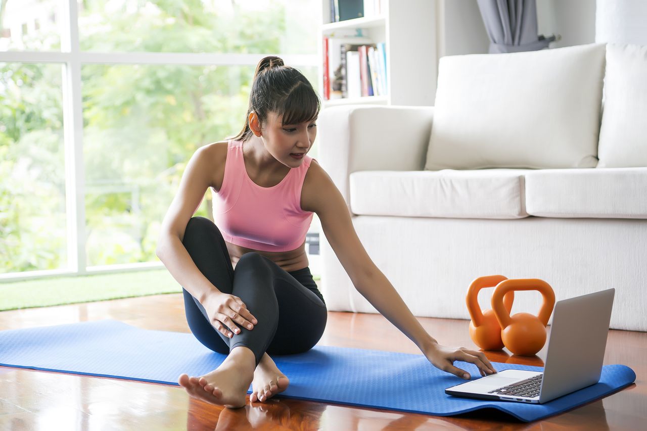 woman working out at home with storage bench