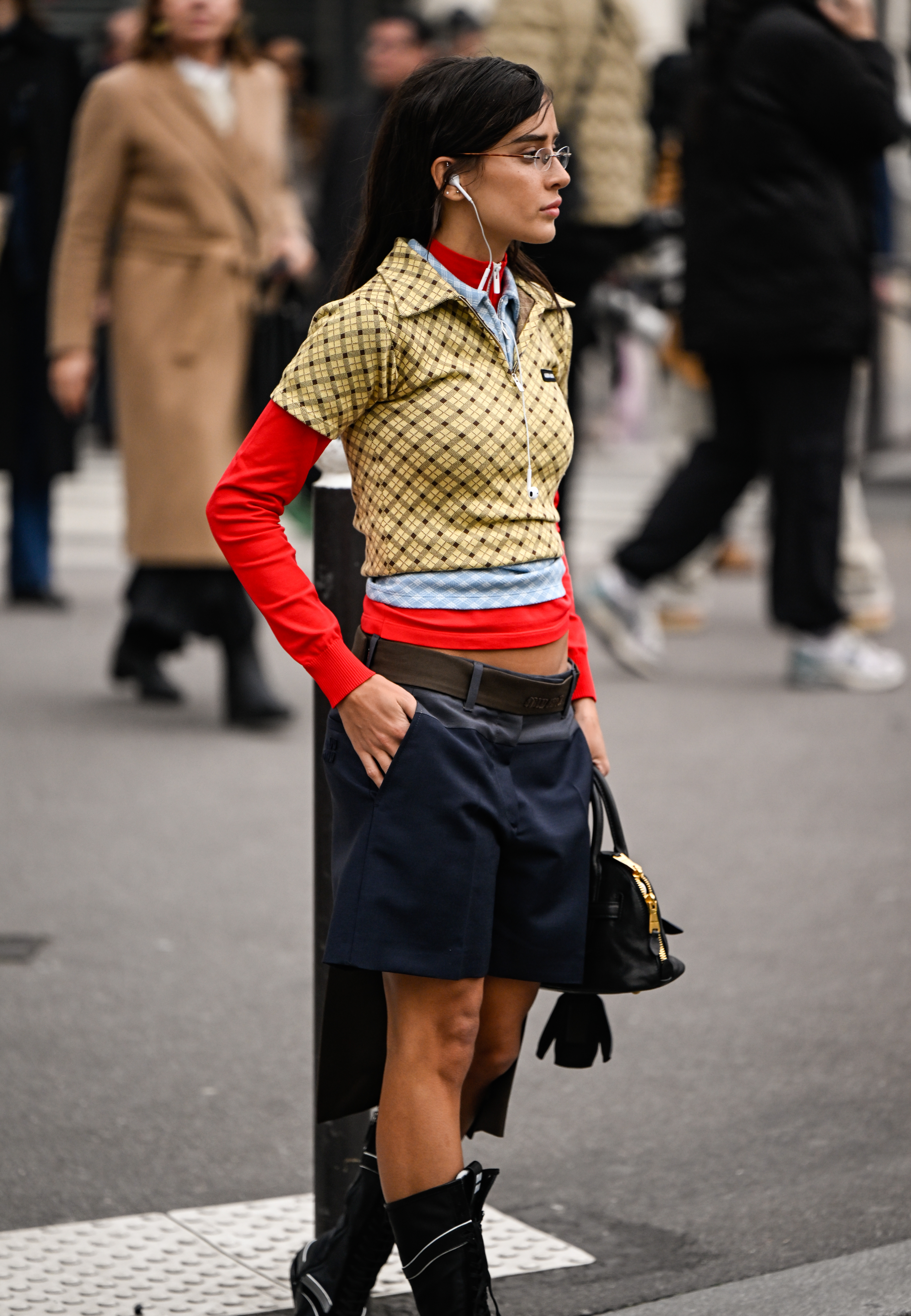 PARIS, FRANCE - MARCH 11: Livia Nunes is seen wearing a red Miu Miu top, yellow plaid Miu Miu cropped top, blue shorts, brown belt, black Miu Miu boots and black Miu Miu bag outside the Miu Miu show during the Womenswear Fall/Winter 2025/2026 as part of Paris Fashion Week on March 11, 2025 in Paris, France. (Photo by Daniel Zuchnik/Getty Images)