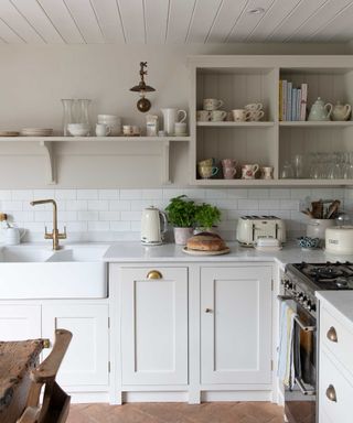 neutral kitchen units with butler sink and brass fittings