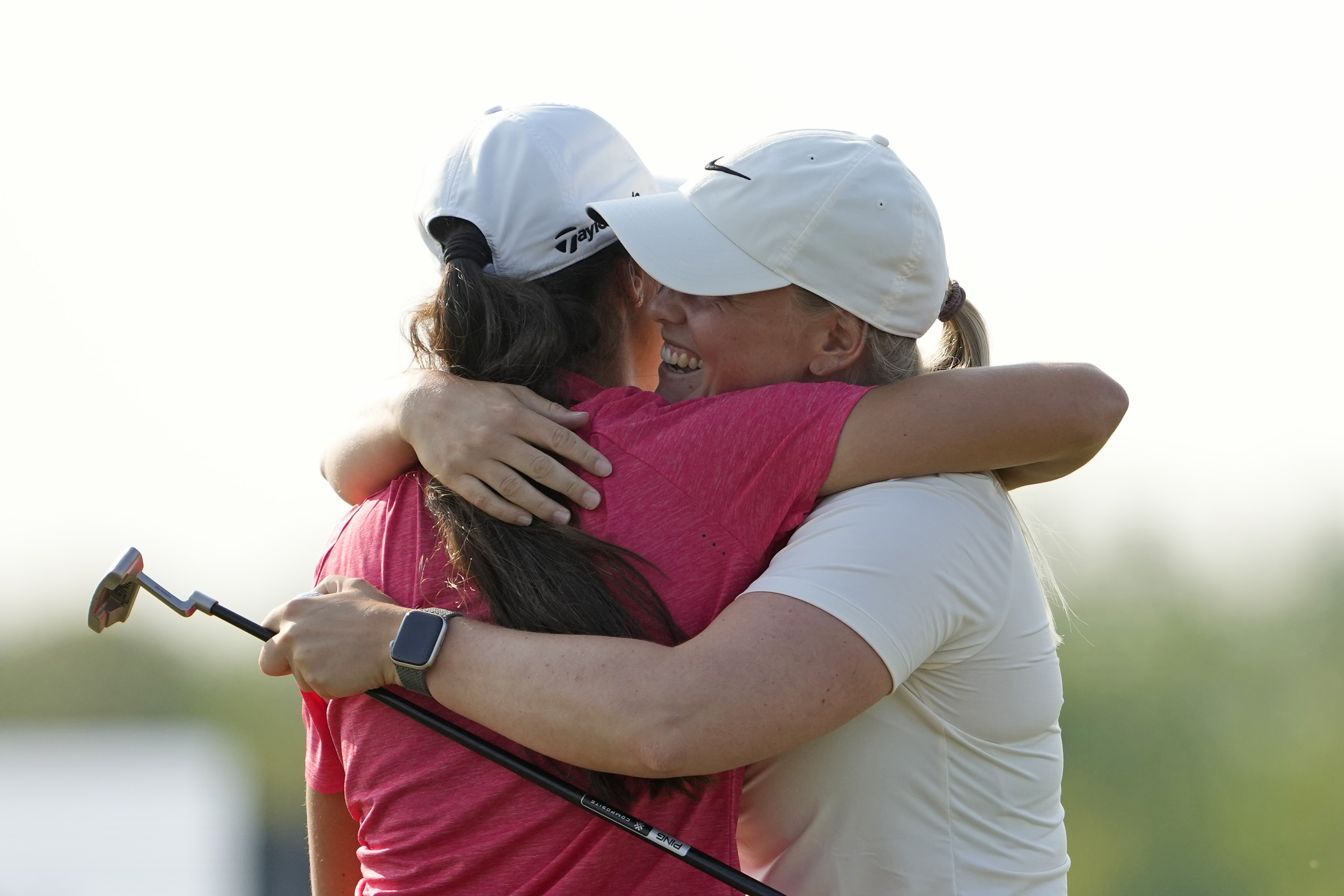 Maja Stark hugs her competitor on the 18th green