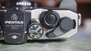 Close up of the Pentax 17 compact film camera's top dials and film crank