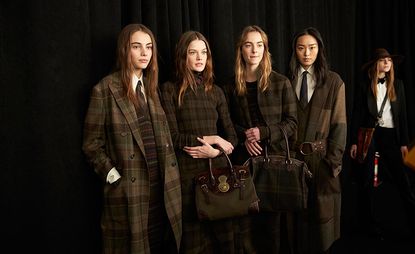 Five models wearing long coats, white shirts, and trousers in browns and greens.