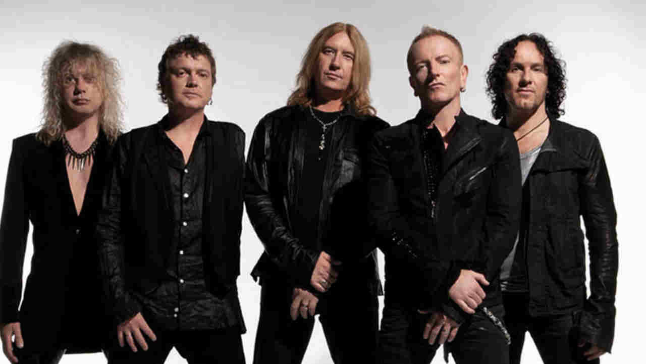 Def Leppard posing for a photograph in 2012