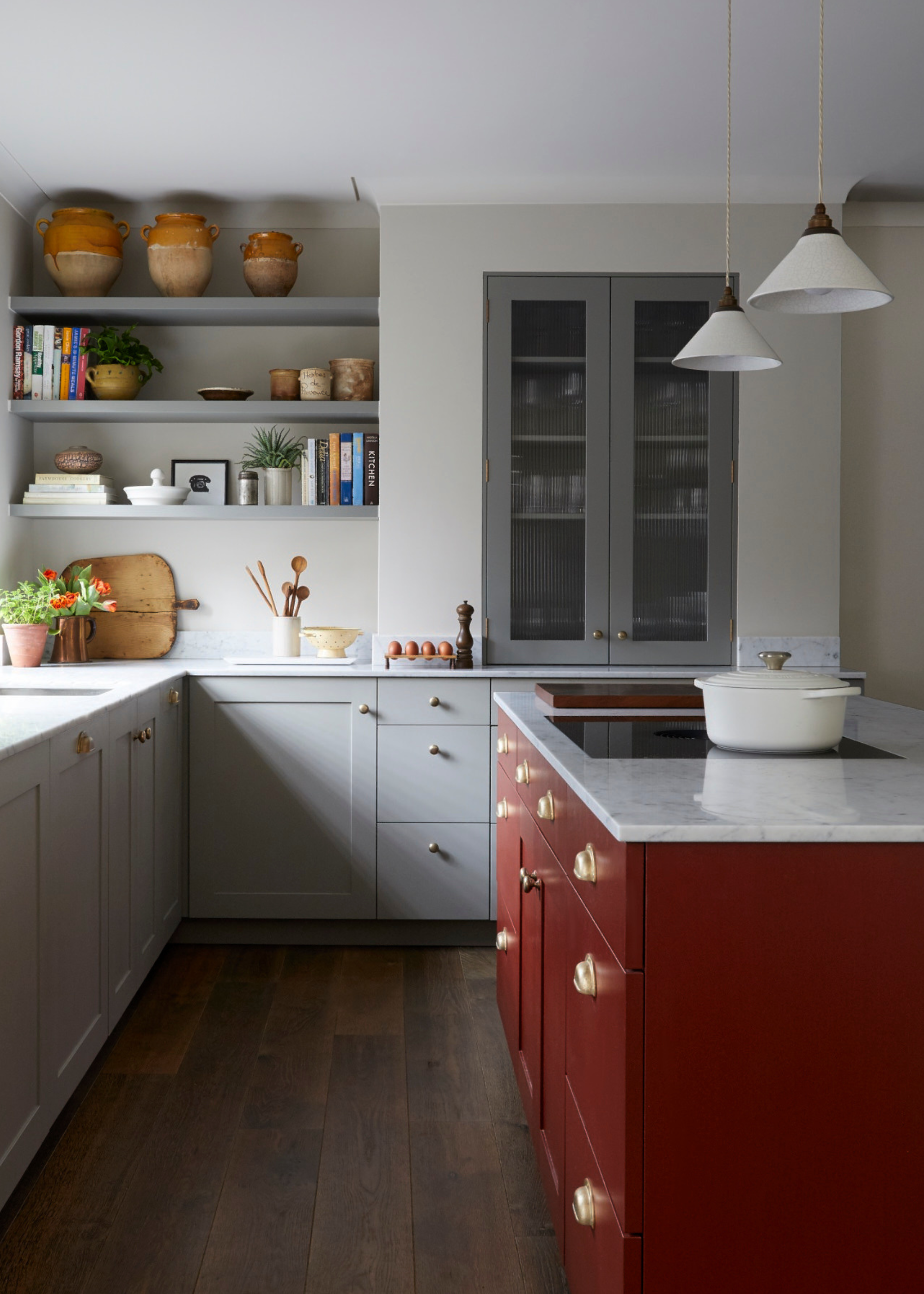 A modern London house with a red kitchen island and fluted glass cabinets