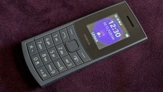 Nokia 110 4G burner phone on a purple cushion