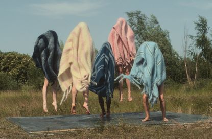 Best blankets and throws: people in blankets jumping in air