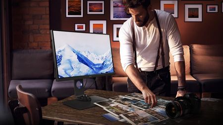 Man looking at BenQ SW271C PhotoVue, one of the best BenQ monitors