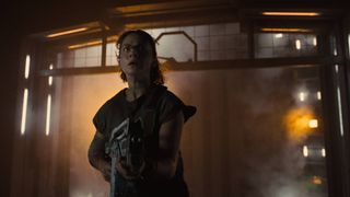 Cailee Spaeny as Rain Carradine holding a gun during the upcoming movie, Alien Romulus.