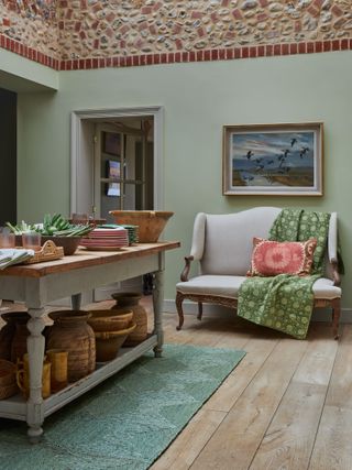 Grey sofa and kitchen island with wooden top