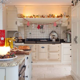 kitchen with white wall white cabinets christmas decorations and white flooring