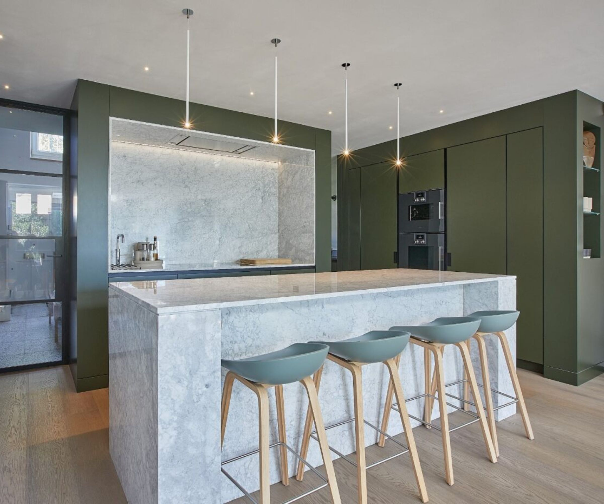 Olive green kitchen cabinets in a minimalist kitchen