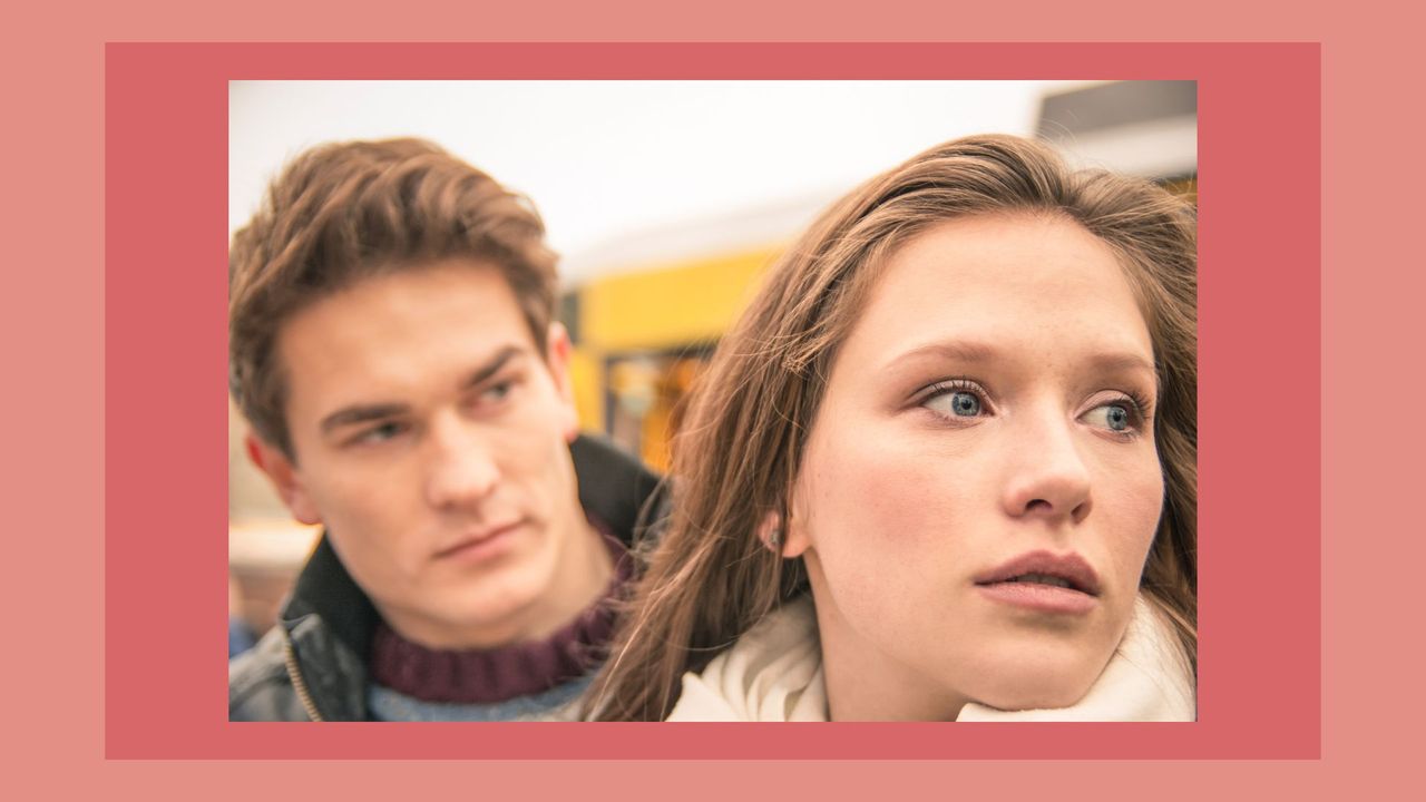 a closeup of a confused couple on a pink background