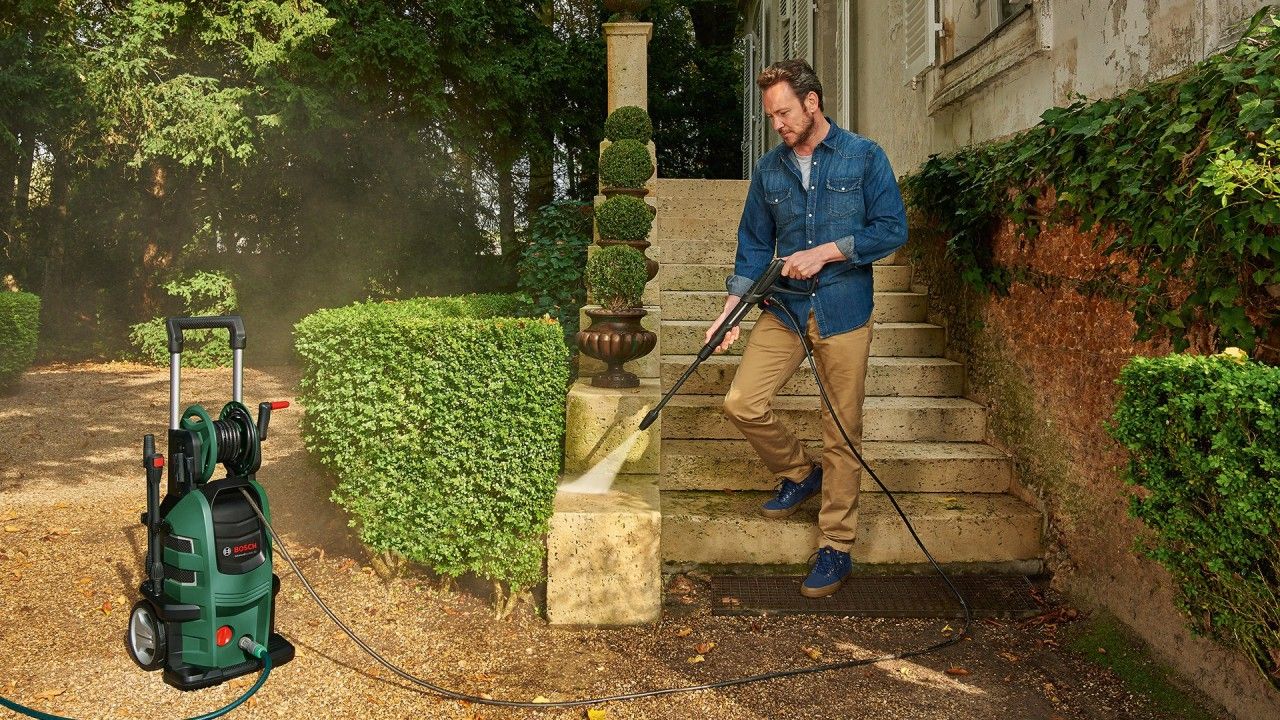 Karcher pressure washer in use to clean a garden