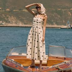 Woman wears headscarf and polka dot Nobody's Child dress