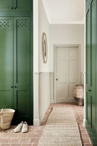 a room with green cabinets and white walls