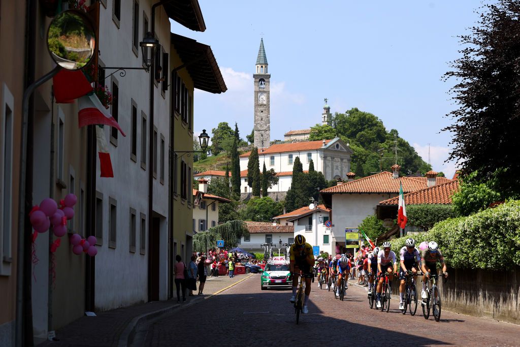 SANTUARIO DI CASTELMONTE ITALY MAY 27 Andrea Vendrame of Italy and AG2R Citroen Team Tobias Bayer of Austria and Team Alpecin Fenix Alessandro Tonelli of Italy and Team Bardiani CSF Faizane Magnus Cort Nielsen of Denmark and Team EF Education Easypost Clement Davy of France and Team Groupama FDJ Edoardo Affini of Italy and Team Jumbo Visma Attila Valter of Hungary and Team Groupama FDJ Koen Bouwman of Netherlands and Team Jumbo Visma Team Blue Mountain Jersey Davide Ballerini of Italy and Team QuickStep Alpha Vinyl Edward Theuns of Belgium and Team Trek Segafredo Mauro Schmid of Switzerland and Team QuickStep Alpha Vinyl and Fernando Gaviria Rendon of Colombia and UAE Team Emirates compete in the breakaway passing through Magnano in Riviera Village during the 105th Giro dItalia 2022 Stage 19 a 178km stage from Marano Lagunare to Santuario di Castelmonte 577m Giro WorldTour on May 27 2022 in Santuario di Castelmonte Italy Photo by Michael SteeleGetty Images